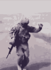 a blurry picture of a soldier holding a gun and dancing .