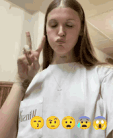 a woman wearing a white shirt with the word denim on the pocket