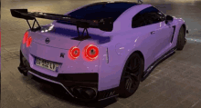 a purple sports car with a license plate that says eg-352-lv