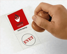 a person is stamping a ballot with the word evet on it