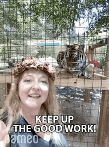 a woman wearing a flower crown stands in front of two tigers and says keep up the good work !