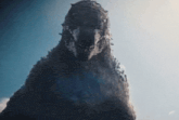 a close up of a monster with spikes on its head against a blue sky