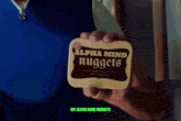 a man eating nuggets in front of a mirror with the words my alpha mind nuggets on the bottom
