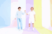 two men are standing next to each other holding hands