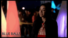 a woman wearing a red shirt that says blue balls on it