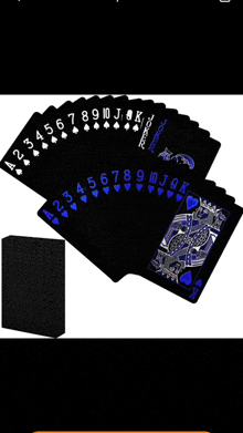 a fan of black and blue playing cards on a table