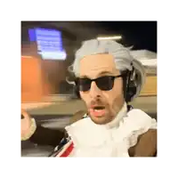 a man wearing a wig and sunglasses is making a surprised face