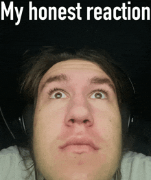 a man wearing headphones is making a funny face with the words my honest reaction above him