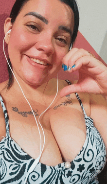 a woman wearing headphones has a tattoo on her chest that says amanda