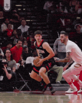 a basketball player wearing a boston jersey dribbles the ball