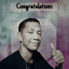 a man is giving a thumbs up in front of a congratulations sign