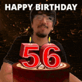 a man is celebrating his 56th birthday by blowing out candles on a cake
