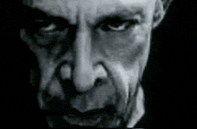 a black and white image of a man 's face