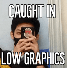 a man wearing a mask takes a picture of himself with the words caught in low graphics below him