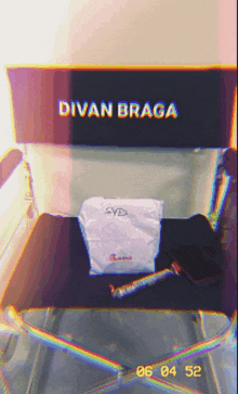 a director 's chair with divan braga written on the back