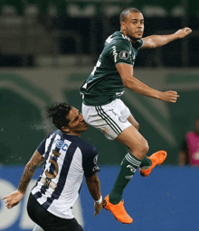 a soccer player wearing a green jersey with the number 5 on it