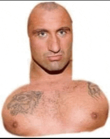 a man with a very long neck and a tattoo on his chest is without a shirt .