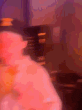 a blurry picture of a person standing in a dark room .