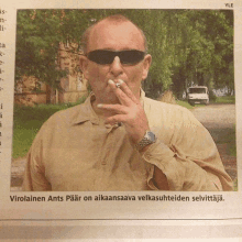 a man is smoking a cigarette in a newspaper article