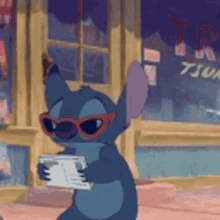 stitch is wearing sunglasses and holding a book in front of a store that says tju