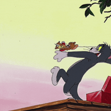 a tom and jerry cartoon shows a cat holding a red stick