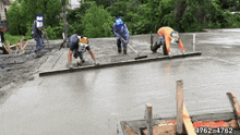 a group of construction workers are working on a concrete surface