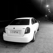 a white car with a license plate that says 50 d 307 na