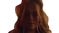 a woman with long blonde hair is looking at the camera