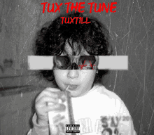 a black and white photo of a child drinking through a straw with the words tux the tune tuxtill on it