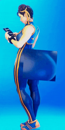 chun li from street fighter is standing in front of a blue background holding a cell phone .