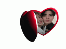a heart shaped mirror with a picture of a man and a woman on it