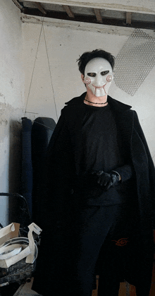 a man wearing a mask and a black cape