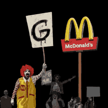 a mcdonald 's sign with a clown holding a sign that says g on it