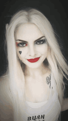 a woman with harley quinn makeup on her face