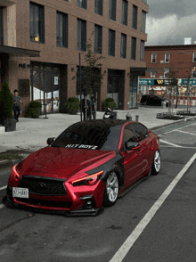 a red car with the license plate kit boyz is parked on the street