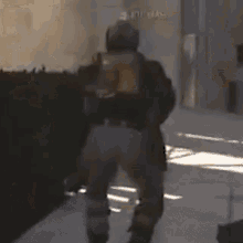 a man in a gas mask is walking down a sidewalk .