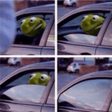 a kermit the frog is sticking its head out of a car window