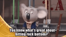 a koala bear is standing in front of a building and says `` you know what 's great about hitting rock bottom ? ''