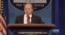 a man in a suit and tie is giving a speech at a podium in front of a sign that says the white house