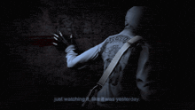 a man with a creed tattoo on his back is standing in front of a wall