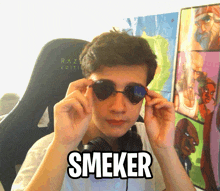 a young man wearing sunglasses with the word smeker on his face