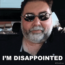 a man with a beard wearing sunglasses and a black shirt says i 'm disappointed