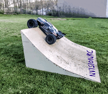 a rc car is going up a ramp that says nvisionrc