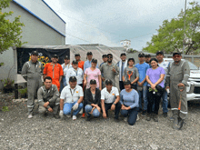 a group of people posing for a picture in front of a sign that says vio vida