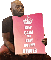 a man holding a pink sign that says keep calm and stay out my nerves