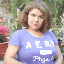 a woman wearing a purple aero phys t shirt