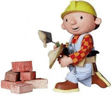 bob the builder is standing next to a pile of bricks and a trowel .