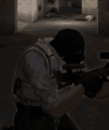 a man in a gas mask holds a gun in a dark room