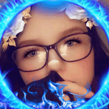 a girl with glasses and a flower crown on her head is surrounded by blue flames