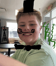 a boy wearing a top hat and bow tie has a drawing of a tower on his face